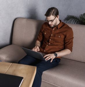 sitting on couch with computer